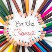 Colouring pencils in circle arrangement with message Be The Change