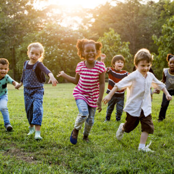 Group,Of,Diverse,Kids,Playing,At,The,Field,Together