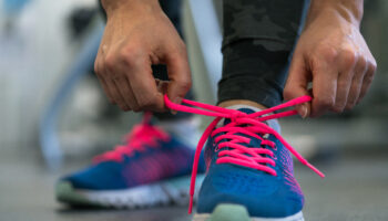 Running,Shoes,-,Woman,Tying,Shoe,Laces.,Closeup,Of,Fitness