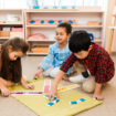 Children,Playing,Educational,Game,On,Floor,In,Montessori,School