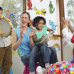 Young,Teacher,With,Children,Playing,Music,In,Classroom