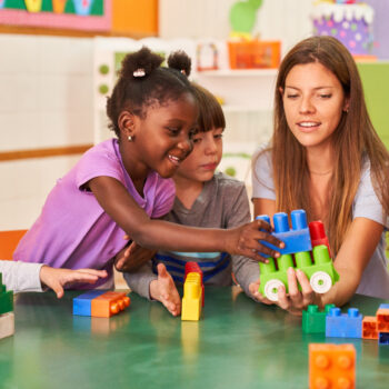 Children,Play,Together,With,Building,Blocks,In,The,International,Kindergarten
