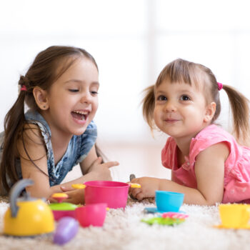 Cute,Kids,Children,Playing,With,Kitchenware,While,Lying,On,Floor