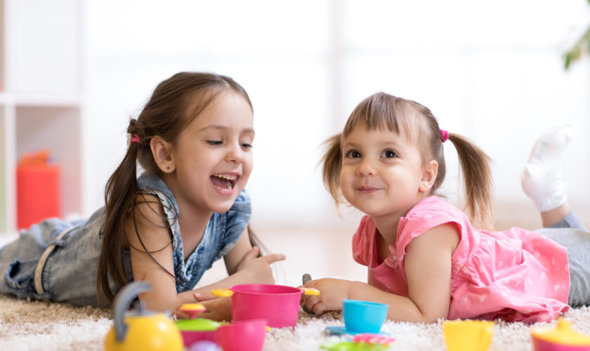 Cute,Kids,Children,Playing,With,Kitchenware,While,Lying,On,Floor