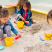 Three,Multiethnic,Little,Children,Playing,With,Plastic,Scoops,And,Buckets
