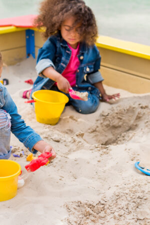 Three,Multiethnic,Little,Children,Playing,With,Plastic,Scoops,And,Buckets